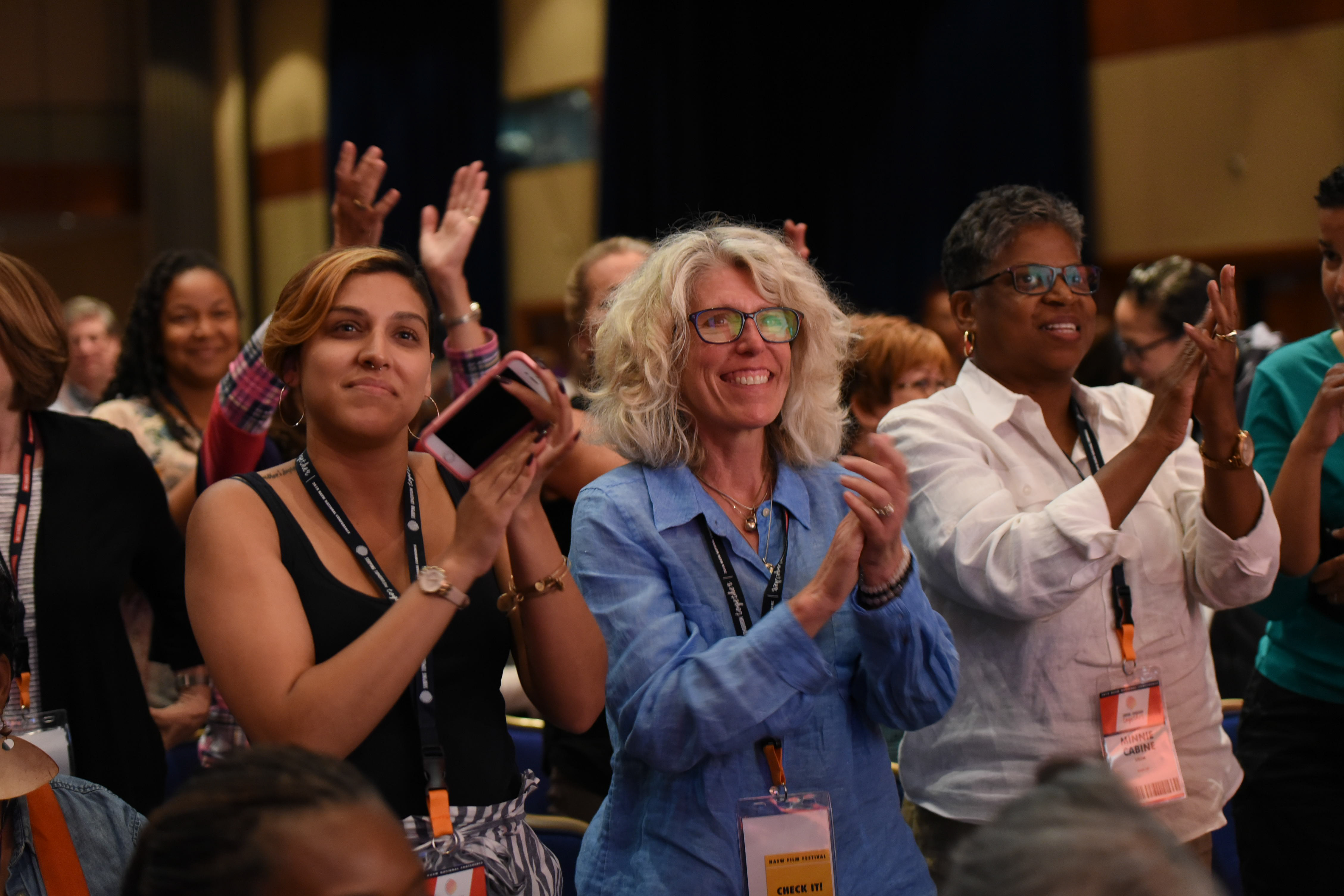 conference attendees give a standing ovation